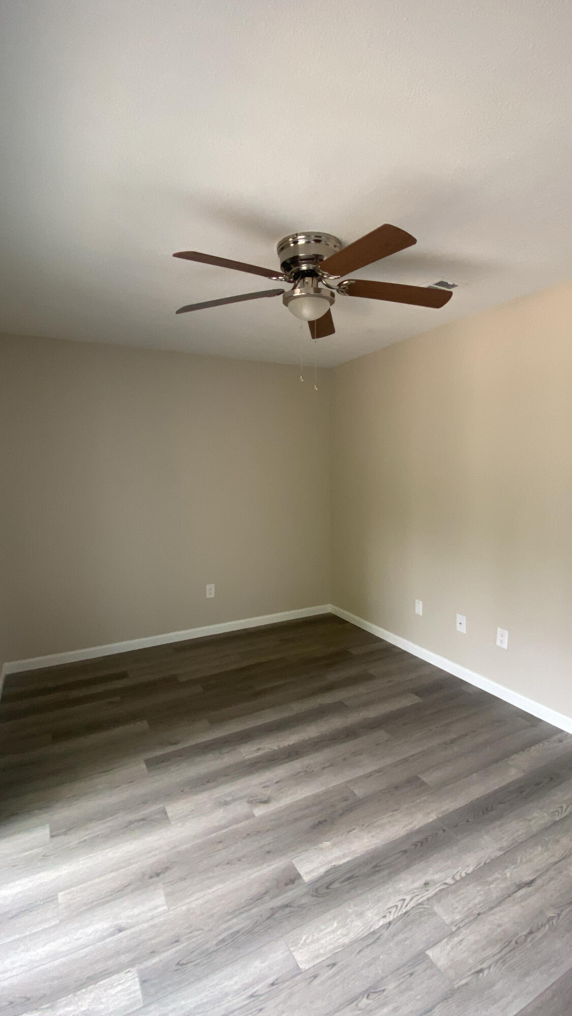 122 Hampton Drive Crestview, FL 32539 - Photo 3 of 12 a view of a room with an empty space and wooden floor