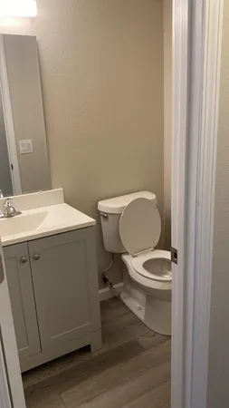a white toilet sitting next to a bathroom sink