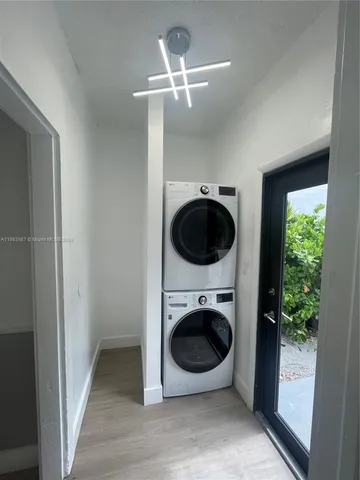 a view of a hallway with washer and dryer