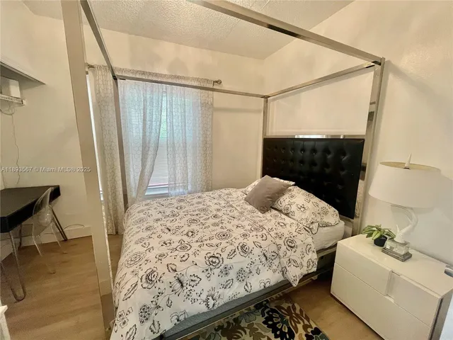 a bedroom with a bed and a mirror