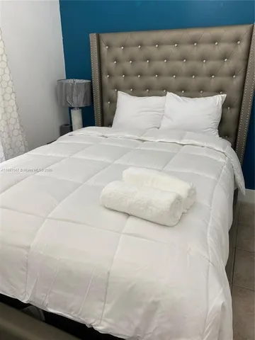 a large white bed in a small room