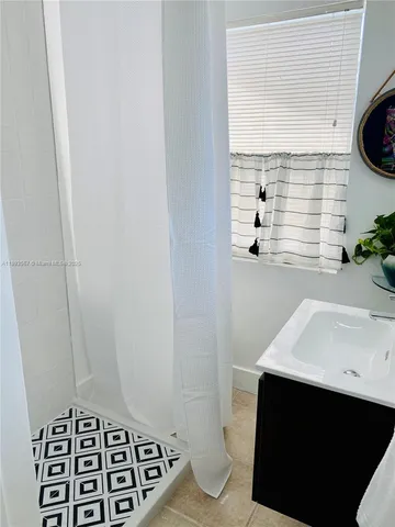 a bathroom with a sink a toilet and a window