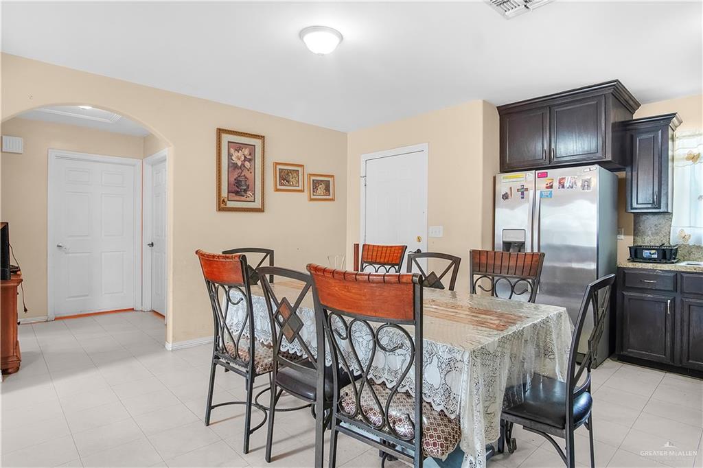 2302 Paris Street Mission, TX 78574 - Photo 11 of 25 a dining room with furniture and stainless steel appliances