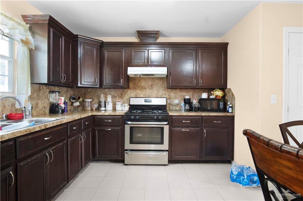 2302 Paris Street Mission, TX 78574 - Photo 13 of 25 a kitchen with a stove and a sink