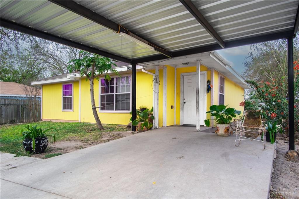 2302 Paris Street Mission, TX 78574 - Photo 2 of 25 a view of a house with potted plants next to a road