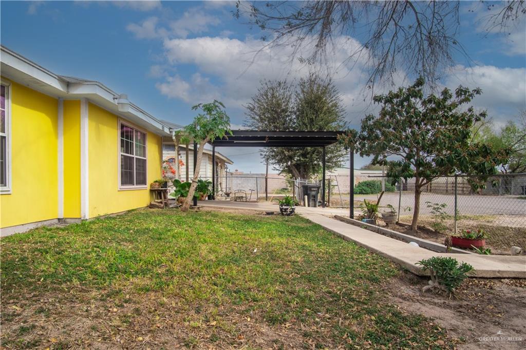 2302 Paris Street Mission, TX 78574 - Photo 3 of 25 a view of a backyard with table and chairs and potted plants