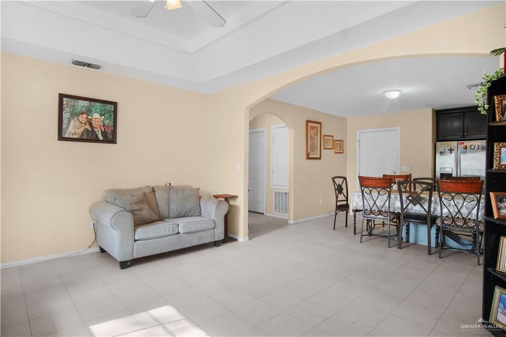 2302 Paris Street Mission, TX 78574 - Photo 5 of 25 a living room with furniture and a dining table with projector