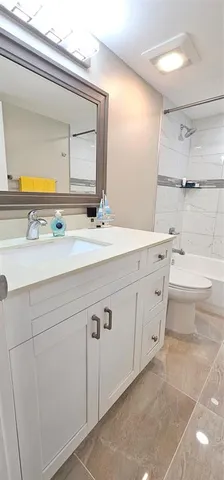 a bathroom with a sink a toilet and mirror