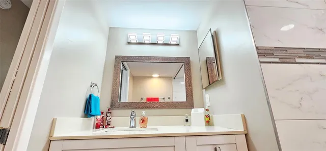 a bathroom with a bathtub sink and mirror