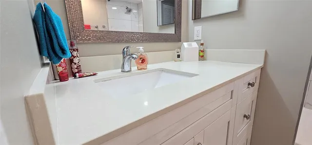a bathroom with a sink and a mirror