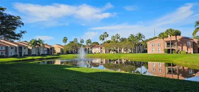 a view of a park with a house in the background