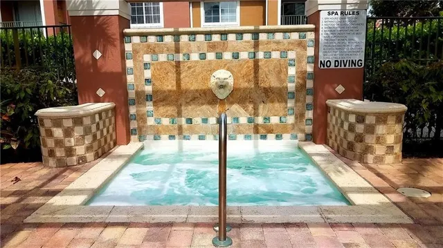 a front view of a building with a garden