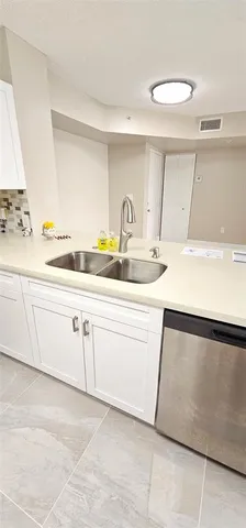 a utility room with cabinets washer and dryer