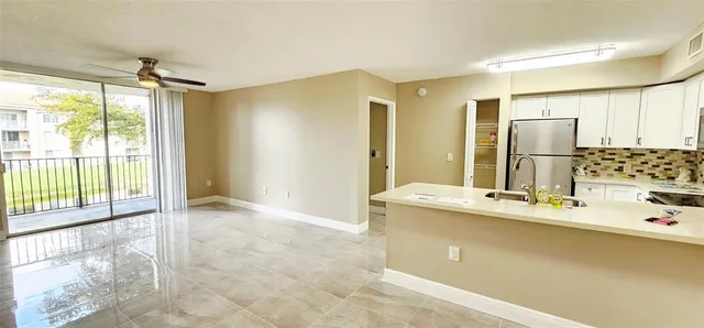 a kitchen with kitchen island a sink appliances and cabinets