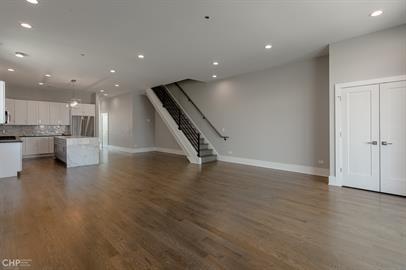 562 West 18th Street, Unit 3W Chicago, IL 60616 - Photo 3 of 14 a view of an empty room with wooden floor kitchen and windows