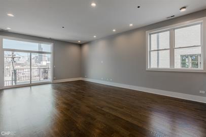 562 West 18th Street, Unit 3W Chicago, IL 60616 - Photo 4 of 14 an empty room with wooden floor and windows