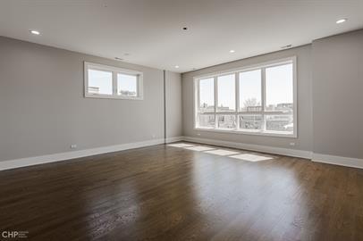 562 West 18th Street, Unit 3W Chicago, IL 60616 - Photo 6 of 14 a view of an empty room with wooden floor and a window