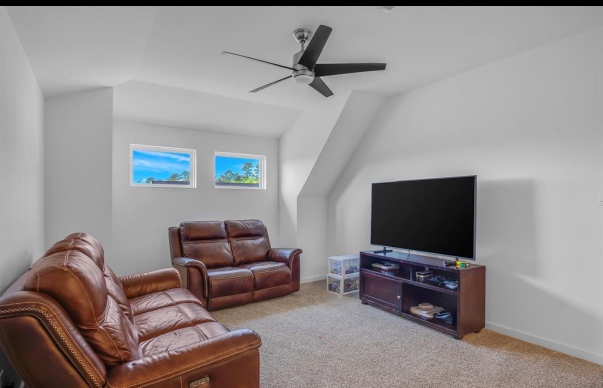14258 Wonder Lake Lane Conroe, TX 77384 - Photo 9 of 12 a living room with furniture and a flat screen tv