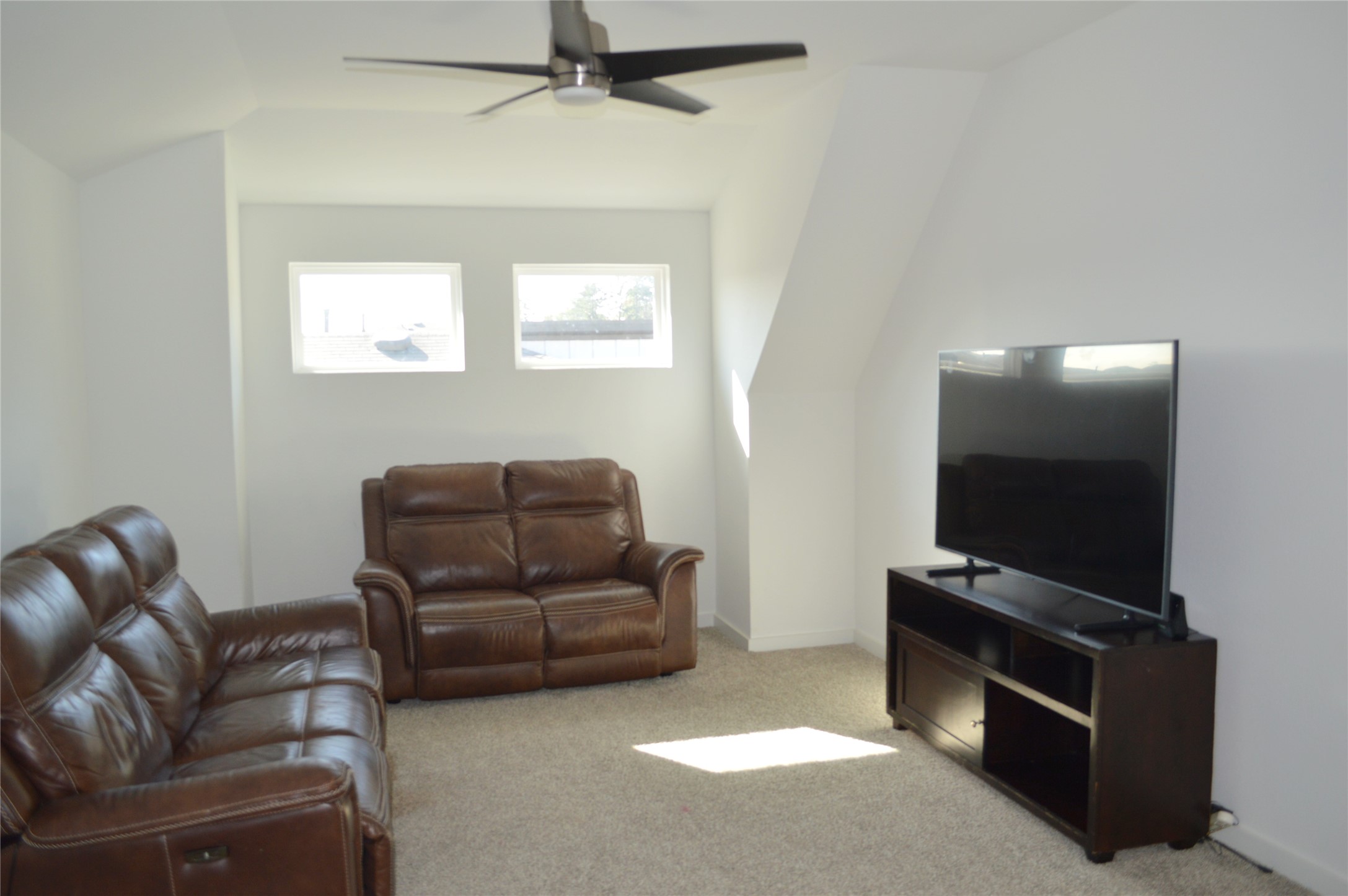 14258 Wonder Lake Lane Conroe, TX 77384 - Photo 10 of 12 a living room with furniture and a flat screen tv