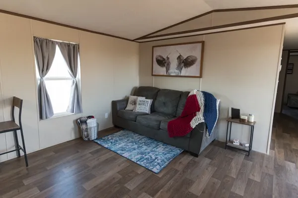 a kitchen with stainless steel appliances granite countertop a stove a sink dishwasher and a refrigerator with wooden floor