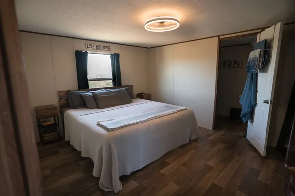 a bedroom with a large bed and a flat screen tv