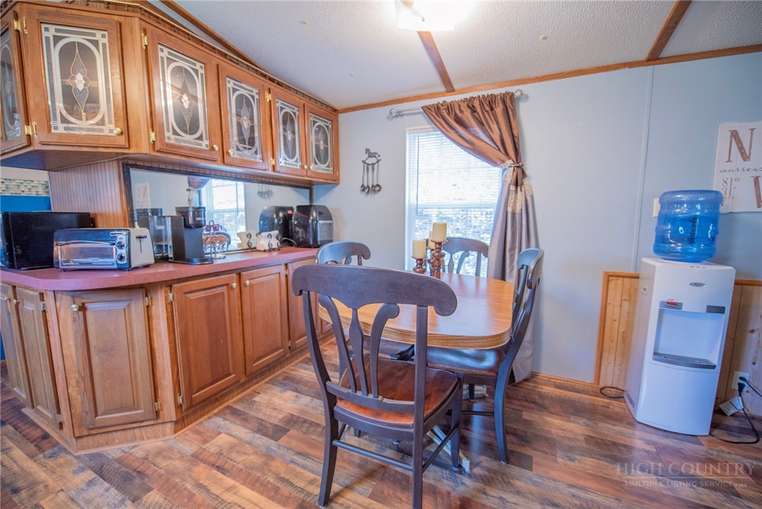 1848 West Mill Creek Road Warrensville, NC 28693 - Photo 20 of 50 a view of a dining room with furniture window and wooden floor