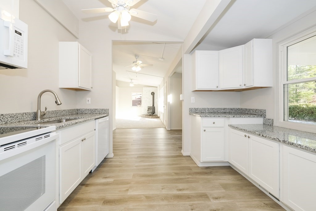 1261 Burts Pit Road Northampton, MA 01062 - Photo 13 of 21 a kitchen with granite countertop a sink cabinets stainless steel appliances and a window