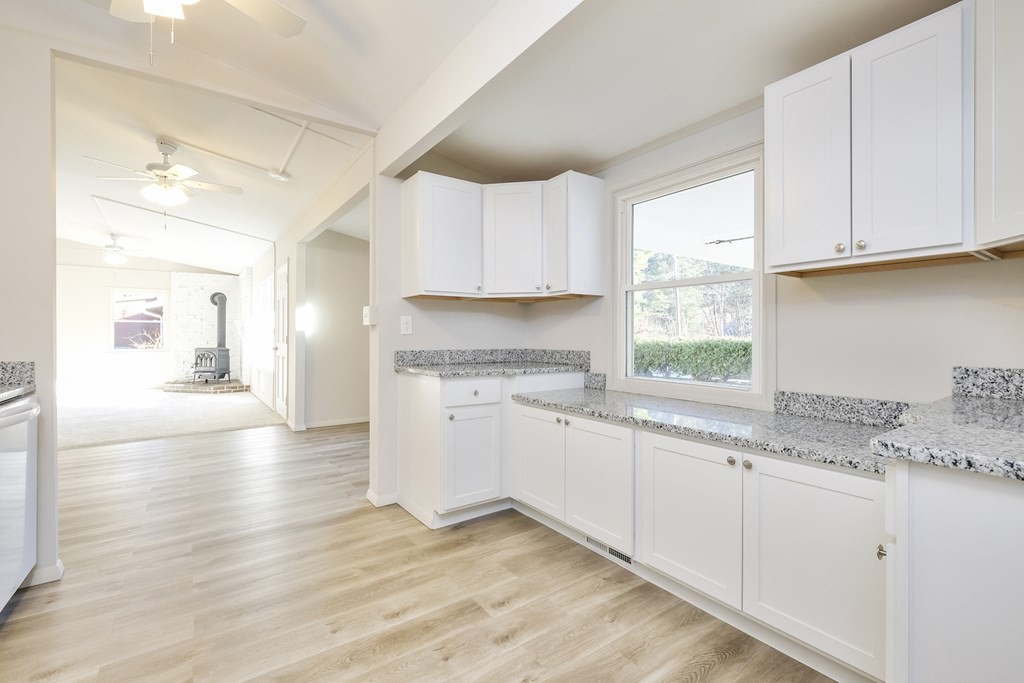 1261 Burts Pit Road Northampton, MA 01062 - Photo 14 of 21 a kitchen with granite countertop white cabinets and a window