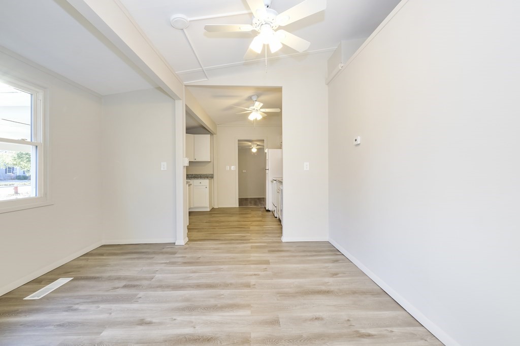 1261 Burts Pit Road Northampton, MA 01062 - Photo 10 of 21 a view of an empty room with wooden floor and a window