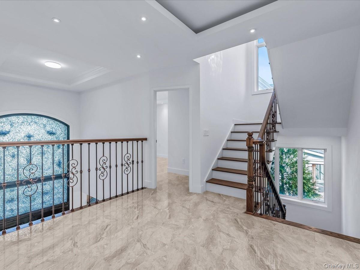 233-12 Bay Street Queens, NY 11363 - Photo 16 of 46 Corridor featuring a tray ceiling and recessed lighting