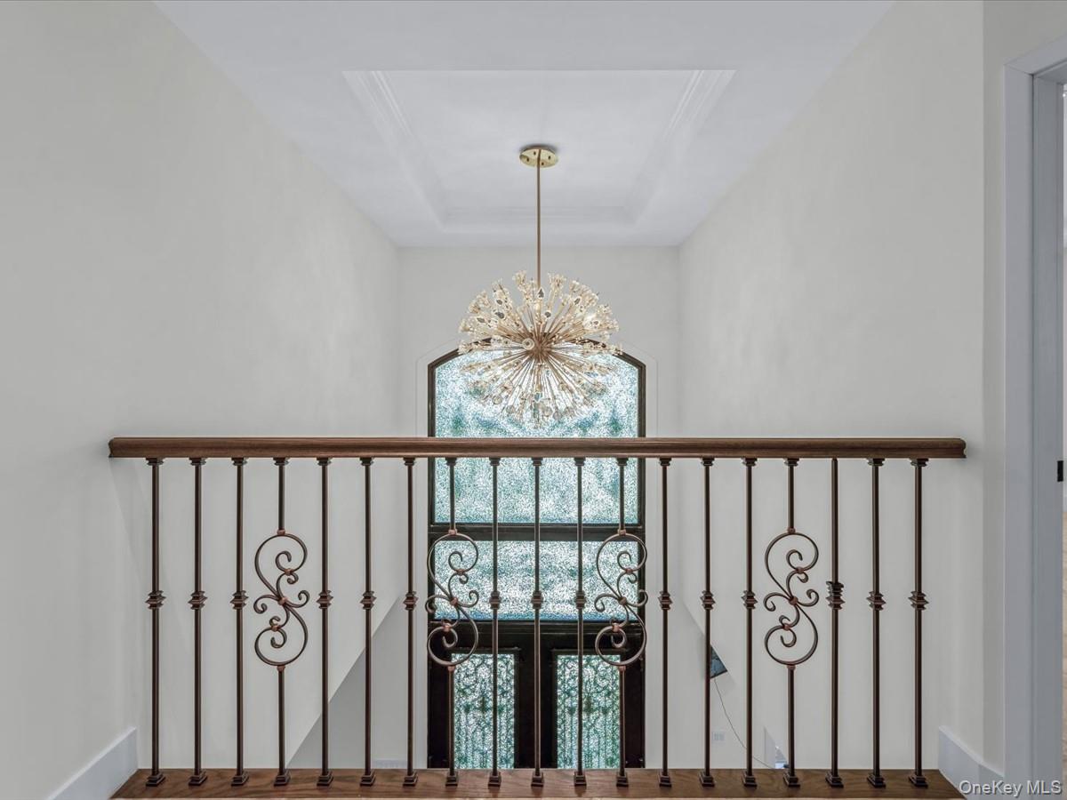 233-12 Bay Street Queens, NY 11363 - Photo 17 of 46 Detailed view of a chandelier and a raised ceiling