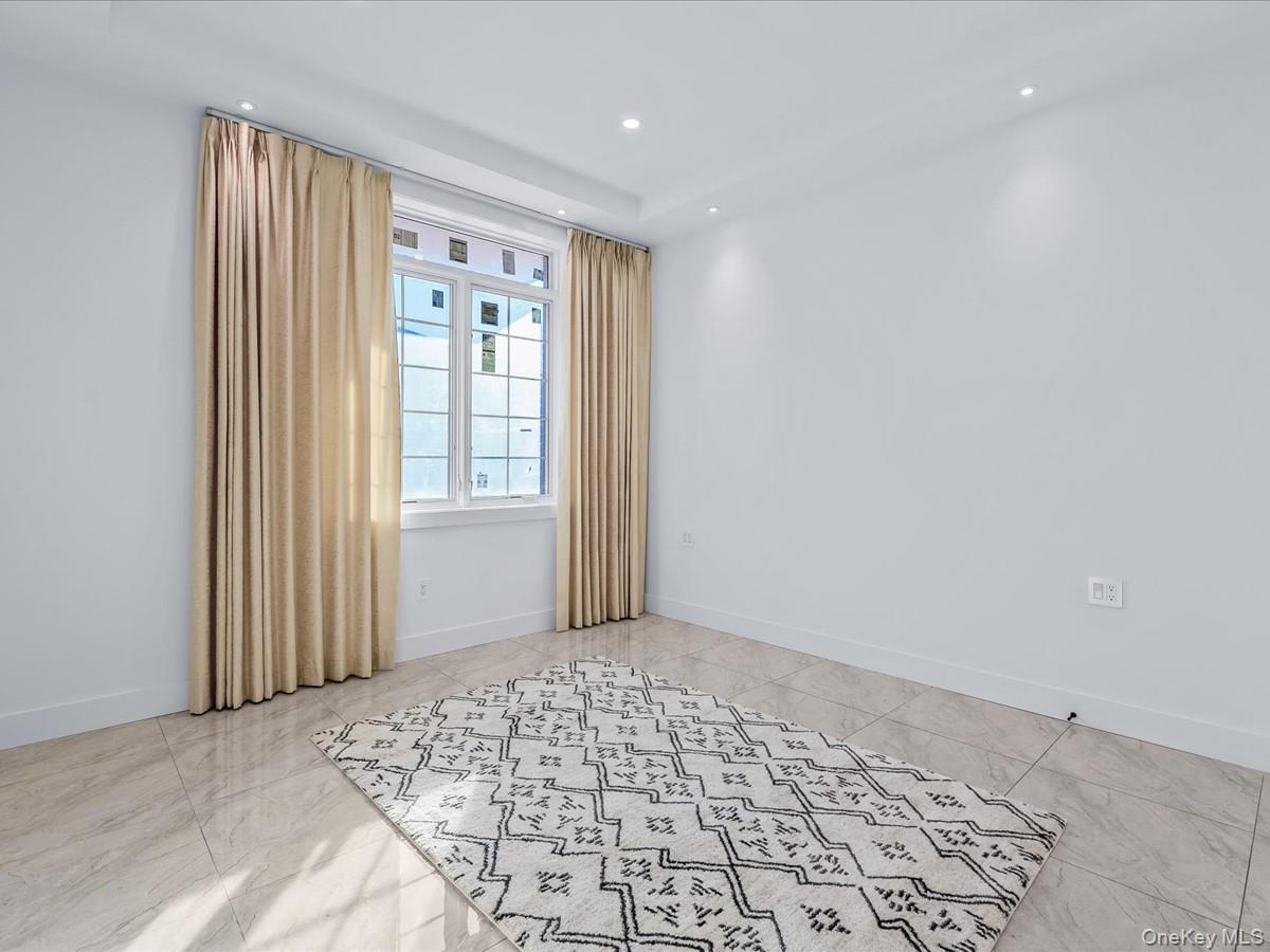 233-12 Bay Street Queens, NY 11363 - Photo 20 of 46 Unfurnished room featuring recessed lighting and baseboards