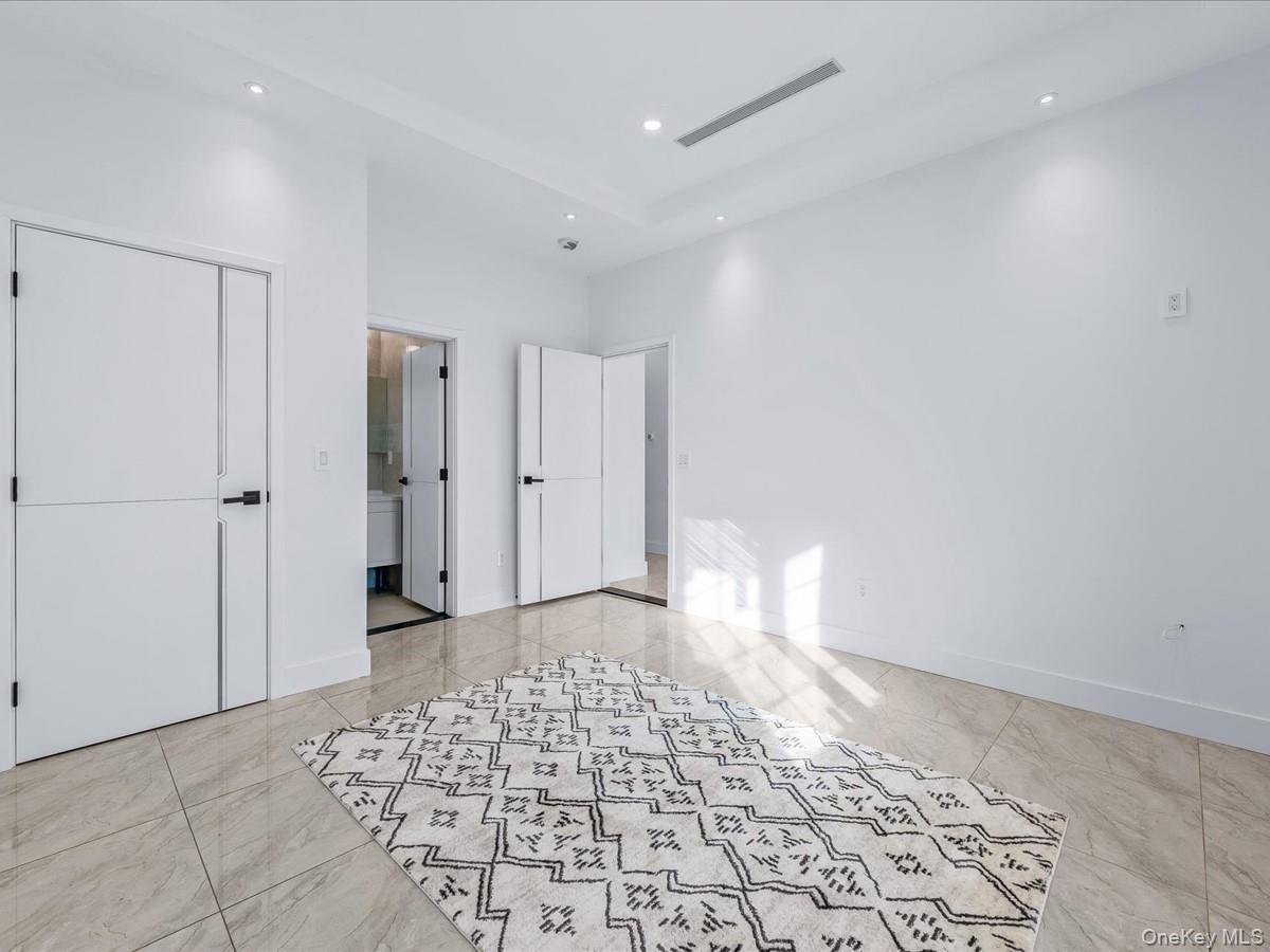 233-12 Bay Street Queens, NY 11363 - Photo 22 of 46 Unfurnished bedroom with recessed lighting and a closet