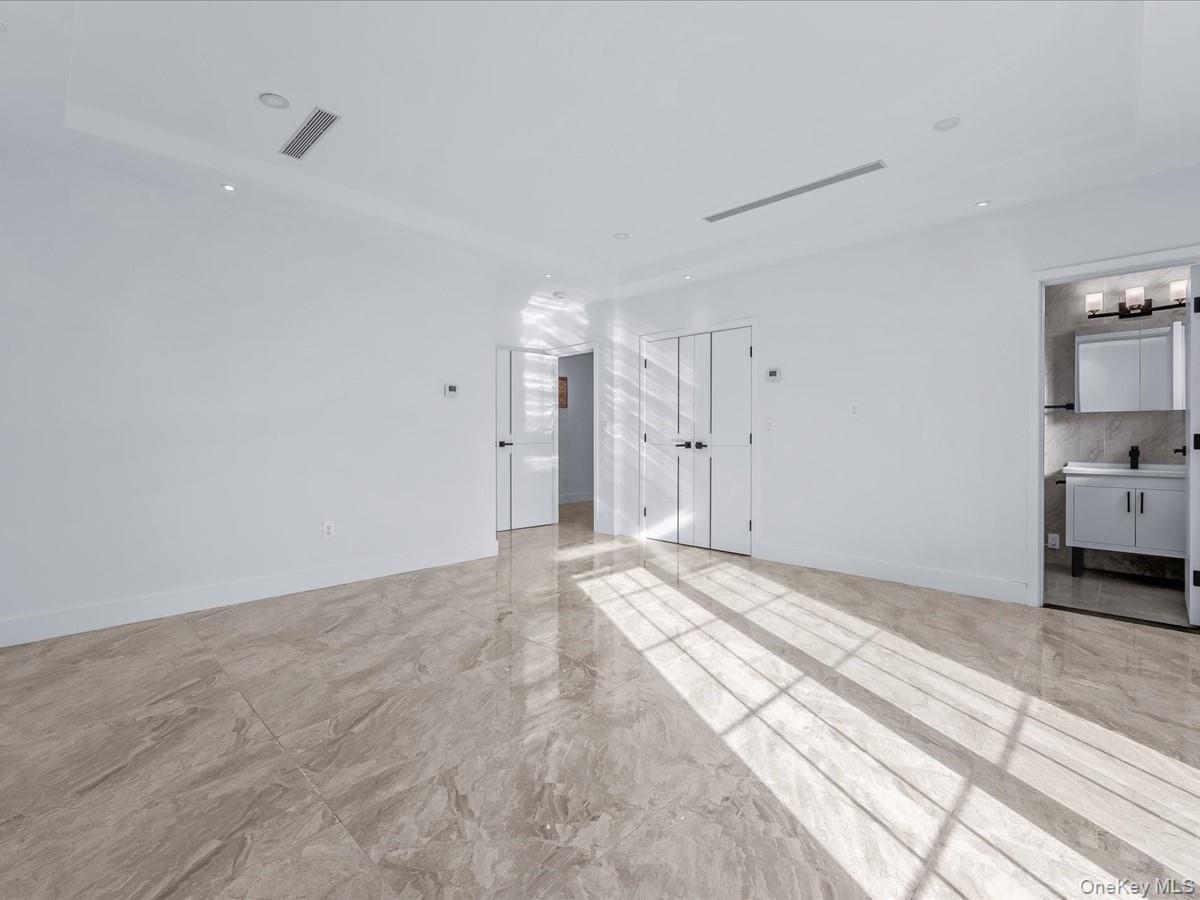 233-12 Bay Street Queens, NY 11363 - Photo 25 of 46 Unfurnished living room with recessed lighting and light marble finish flooring