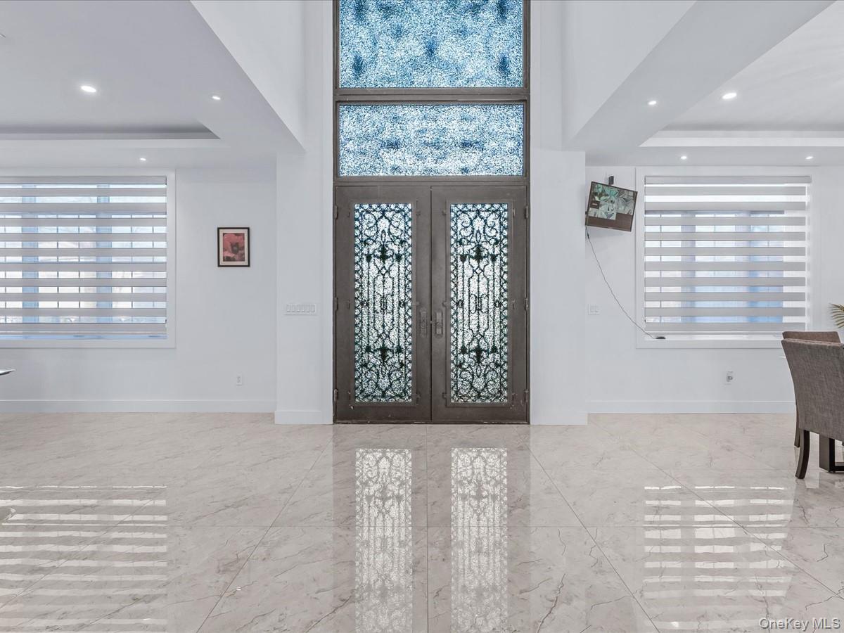 233-12 Bay Street Queens, NY 11363 - Photo 3 of 46 Foyer with a tray ceiling, french doors, recessed lighting, and healthy amount of natural light