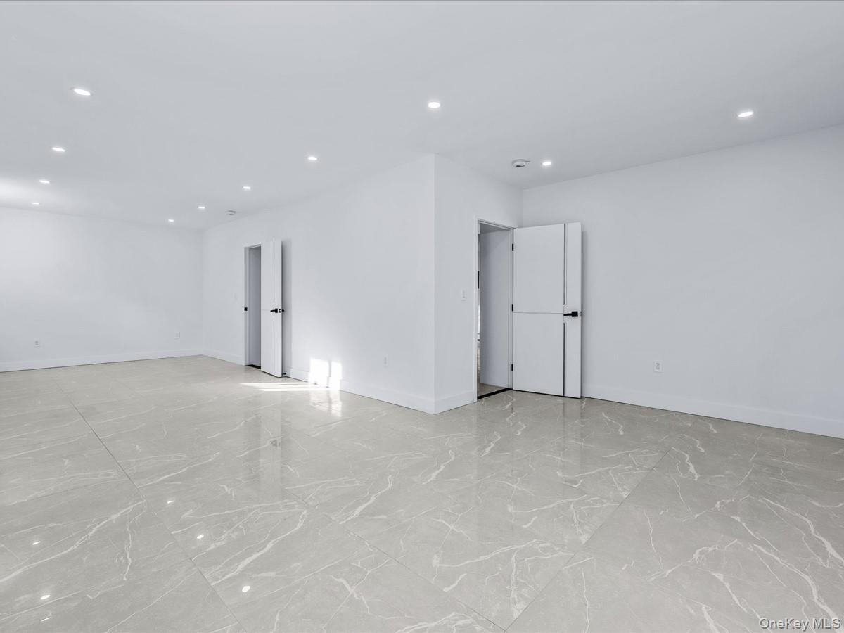 233-12 Bay Street Queens, NY 11363 - Photo 31 of 46 Unfurnished room featuring recessed lighting and light marble finish flooring