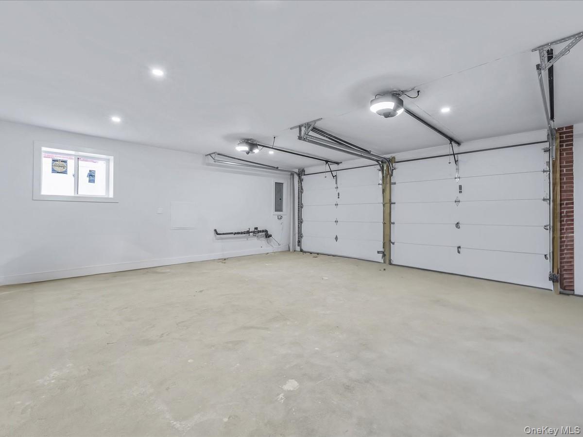 233-12 Bay Street Queens, NY 11363 - Photo 32 of 46 Garage featuring a garage door opener and electric panel