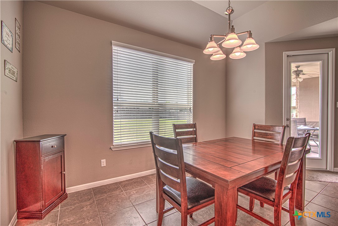 623 Coventry Drive Temple, TX 76502 - Photo 13 of 38 a view of a dining room with furniture wooden floor and chandelier