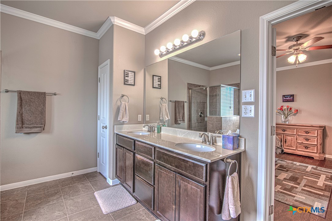 623 Coventry Drive Temple, TX 76502 - Photo 21 of 38 a bathroom with a granite countertop sink and a mirror