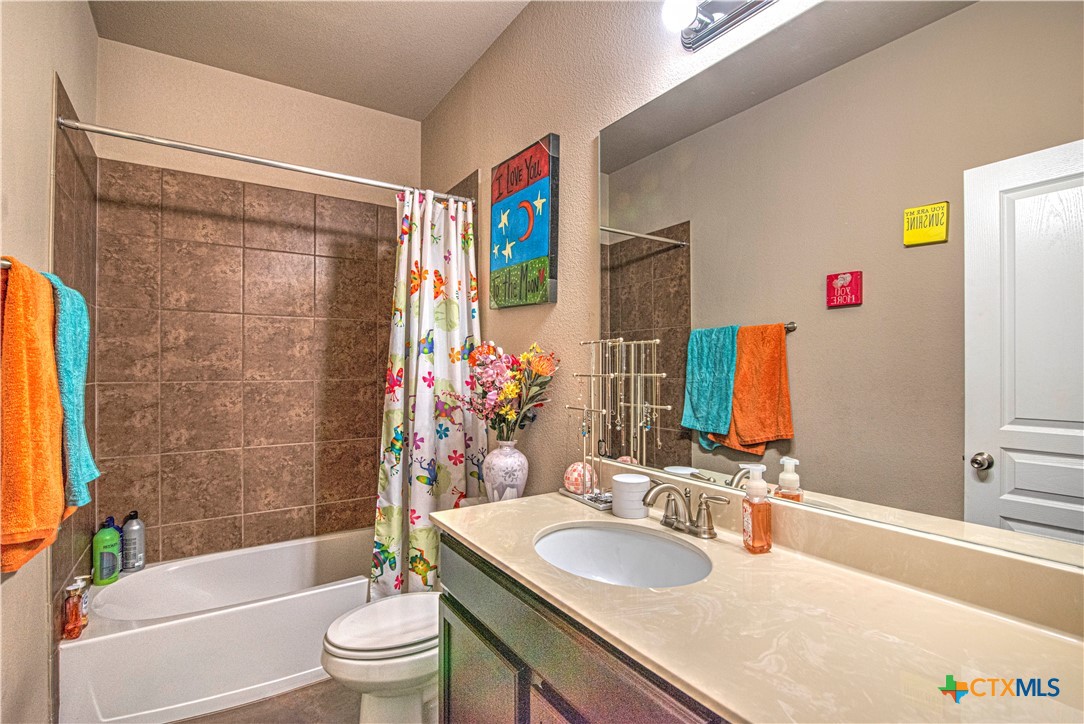 623 Coventry Drive Temple, TX 76502 - Photo 27 of 38 a bathroom with a granite countertop sink and a mirror
