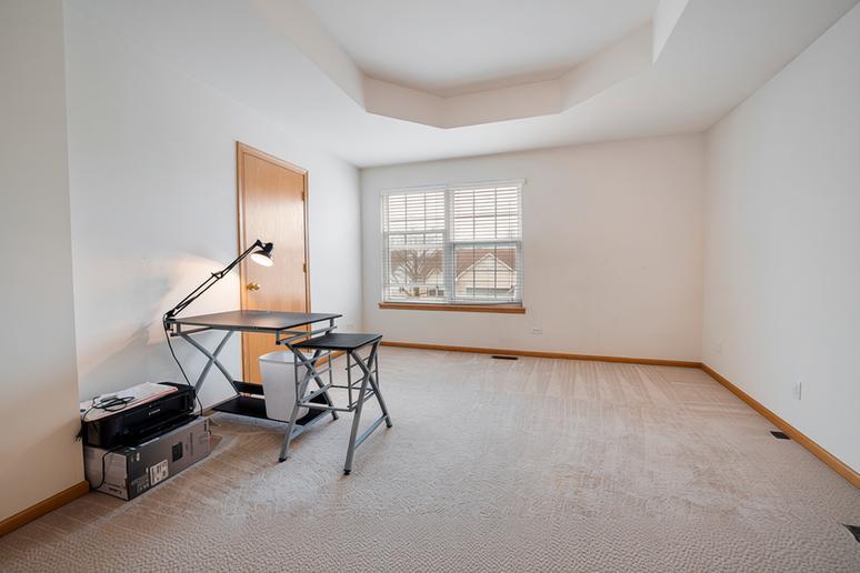 1014 Edinburgh Court Joliet, IL 60431 - Photo 14 of 25 an empty room with windows and wooden floor