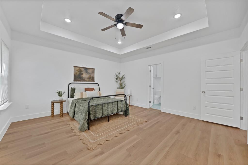801 Tierney Road Fort Worth, TX 76112 - Photo 21 of 30 Recessed lighting, wood-finish flooring, and tray ceiling with a built-in ceiling fan