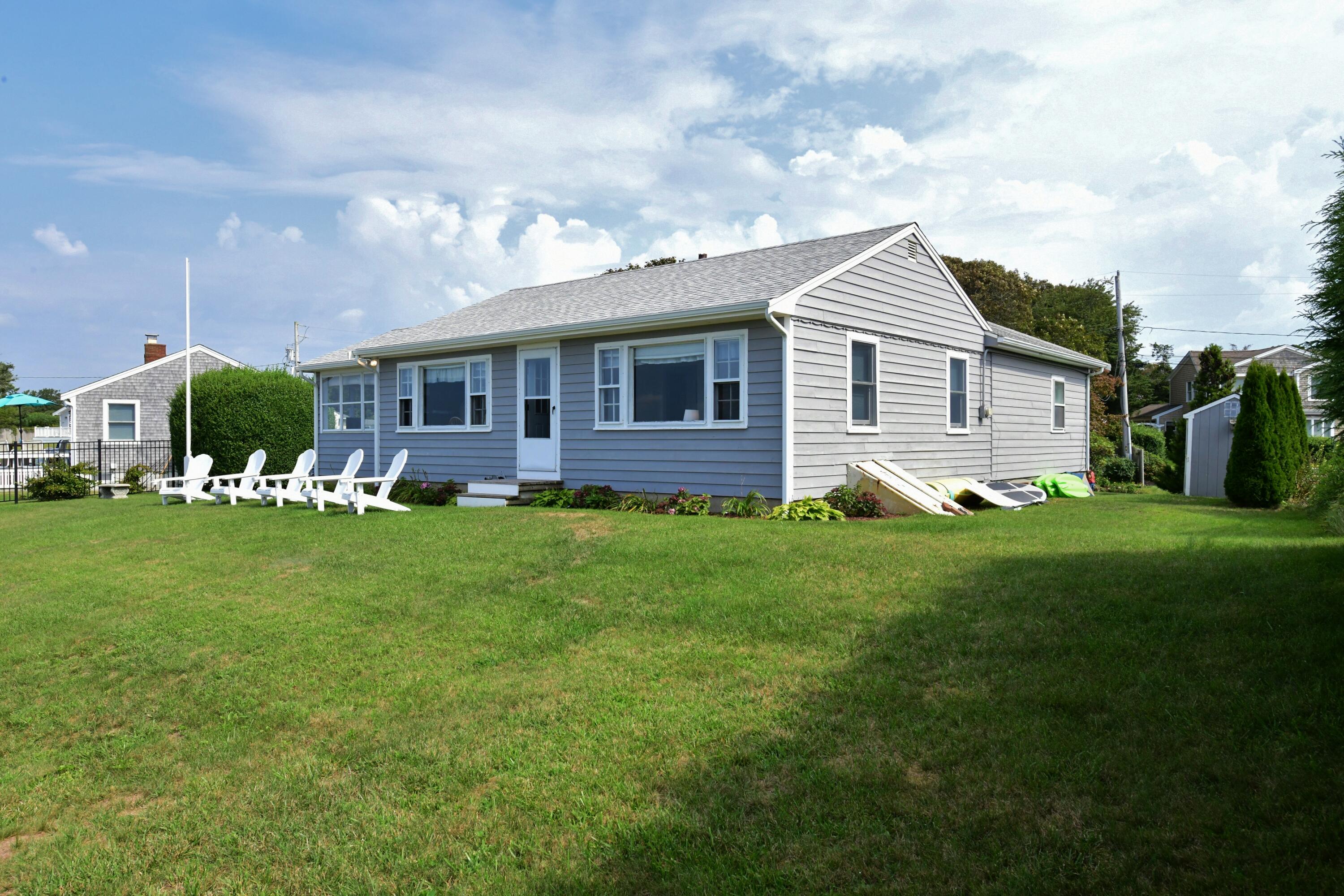 a front view of house with yard and green space