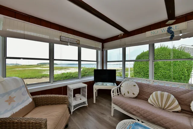 a living room with furniture and a floor to ceiling window