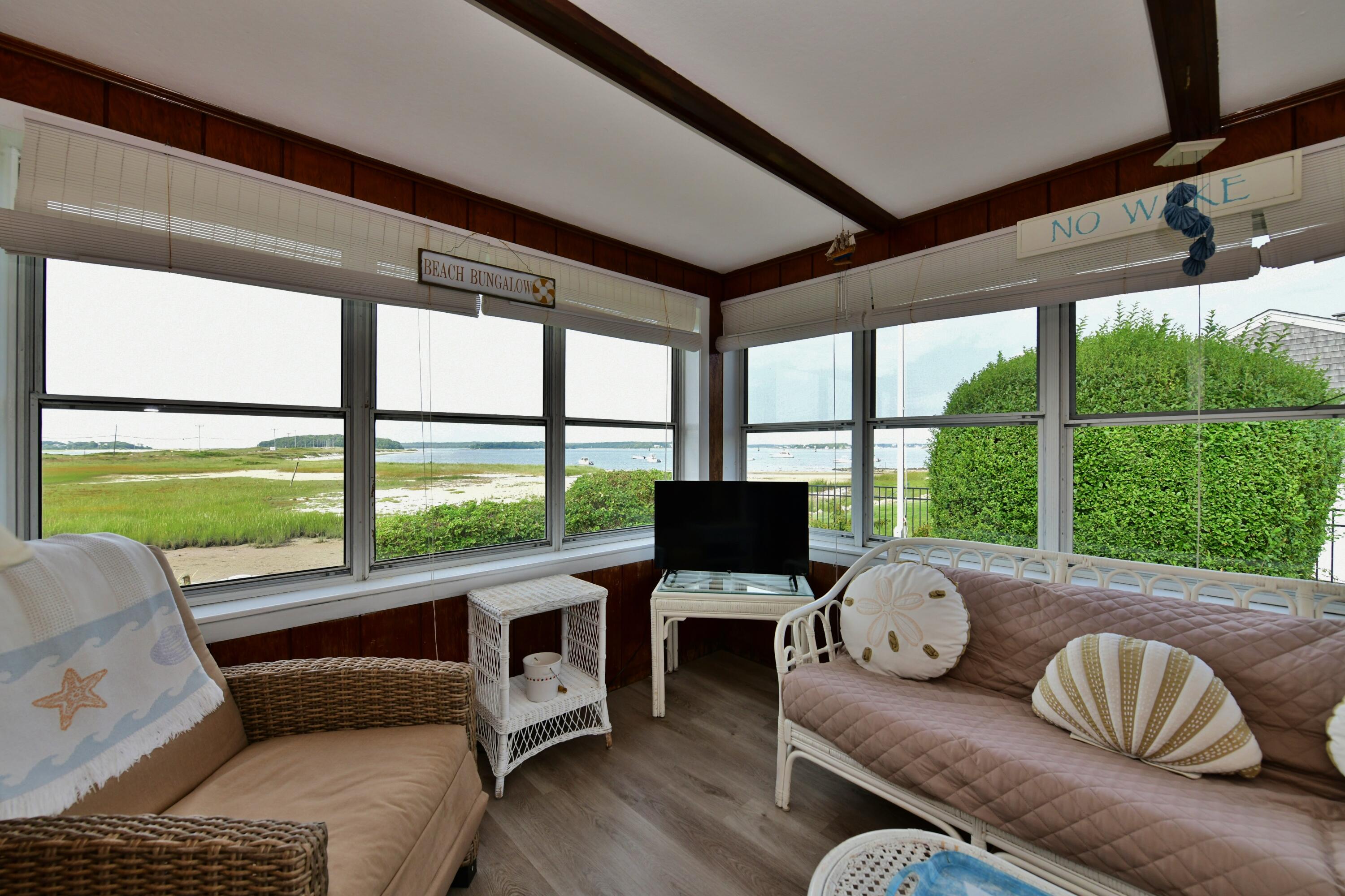 5 Spindrift Lane, Unit WINTER Buzzards Bay, MA 02532 - Photo 13 of 34 a living room with furniture and a floor to ceiling window