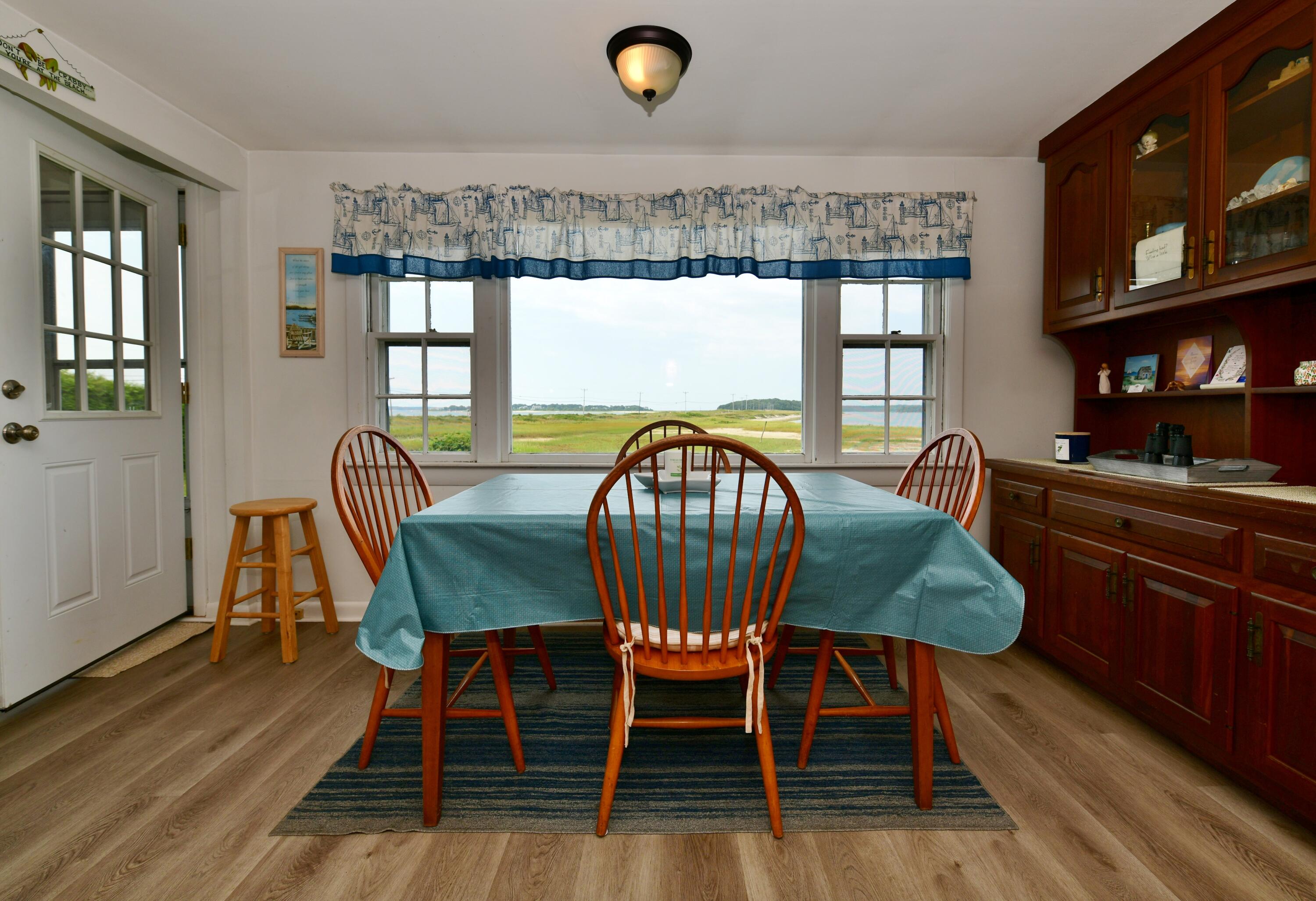 5 Spindrift Lane, Unit WINTER Buzzards Bay, MA 02532 - Photo 16 of 34 a view of a dining room with furniture window and wooden floor