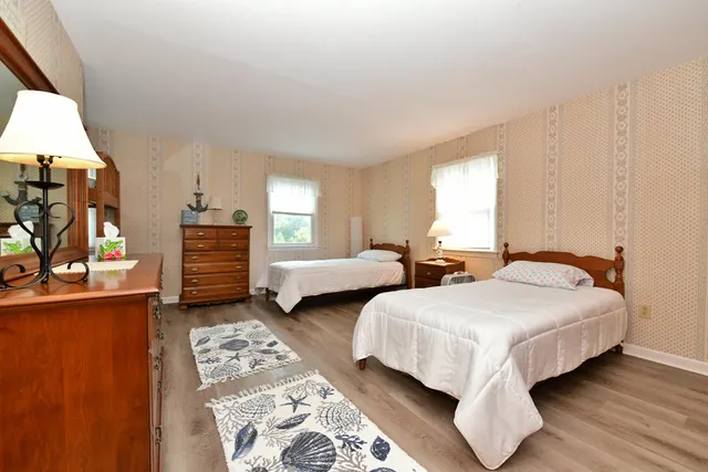 a bedroom with two beds and a couch