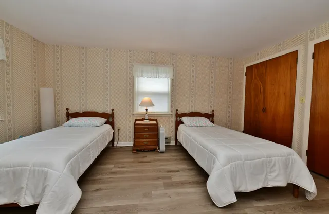 a bed room with a bed and a night stand