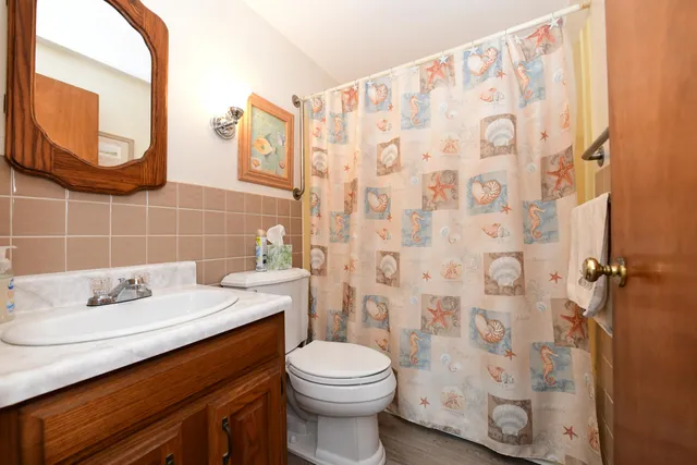 a bathroom with a sink toilet and a mirror