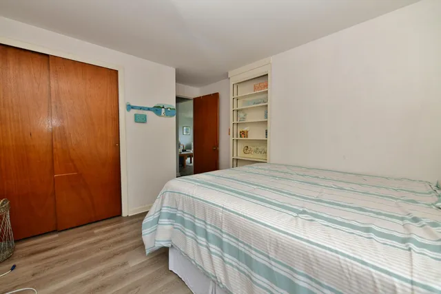 a bedroom with a bed and a closet